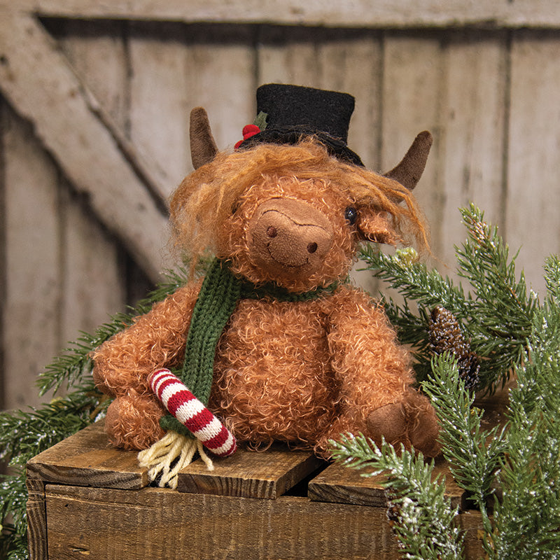SITTING HIGHLAND COW W/ CANDY CANE
